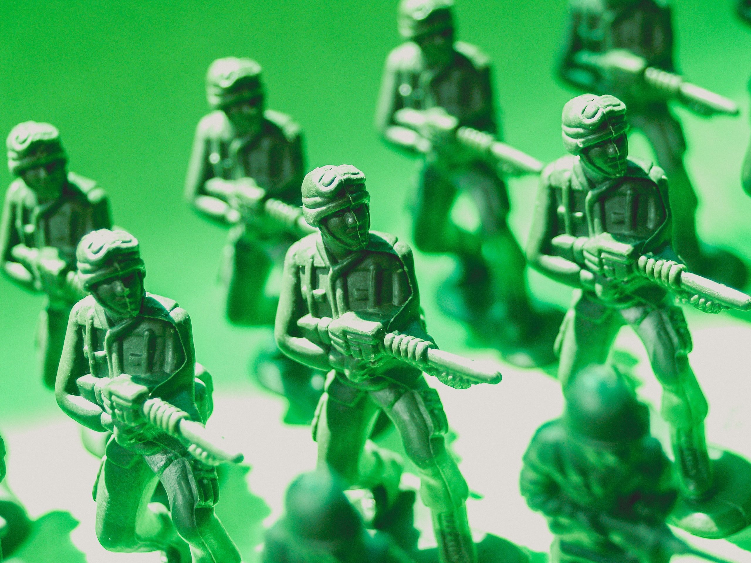 Green toy soldiers stand in position ready to fight off other toy soldiers similar to the way breach and attack simulation services must detect and fend off threats.
