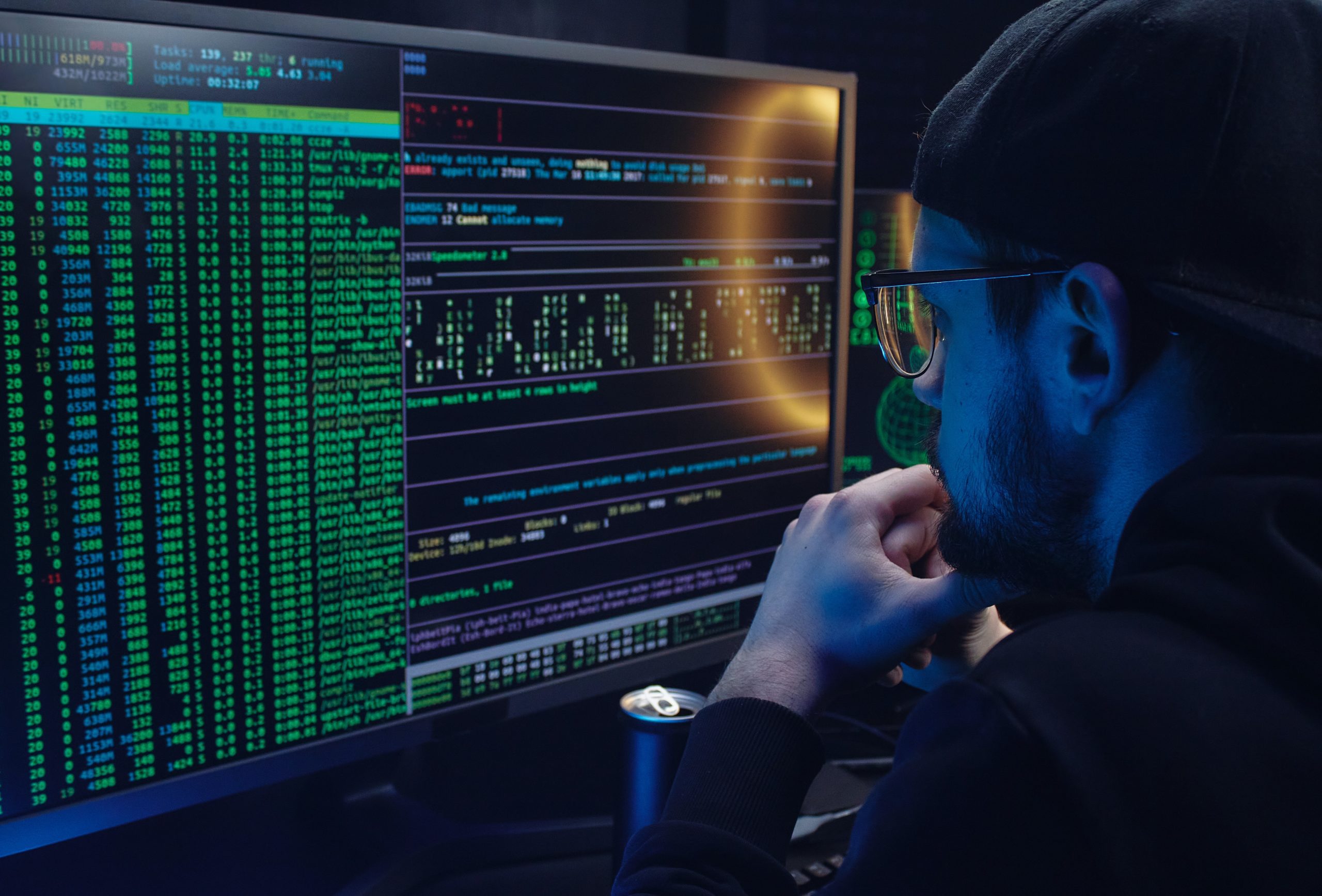 A picture of an IT professional looking at a screen filled with all of the code and programming jargon you can imagine as he parses through the top full disk encryption software products.