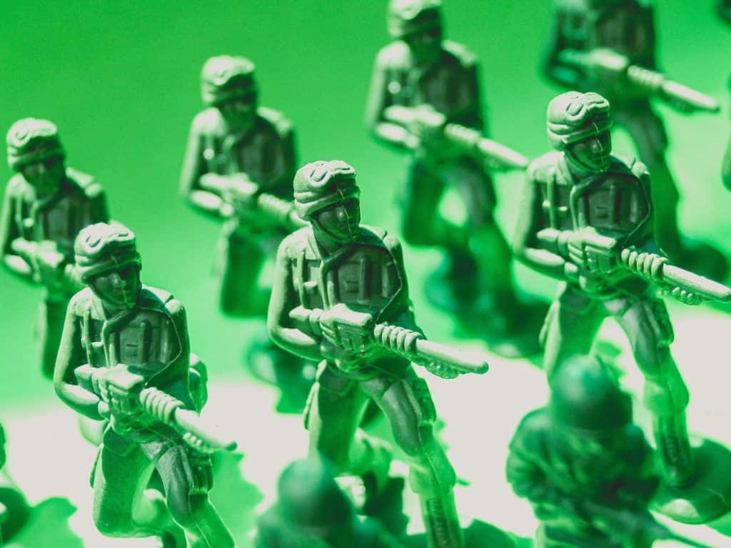 A group of green toy soldiers positioned in a row as this article is about the top Breach and Attack Simulation (BAS) solutions to fend off the latest threats.