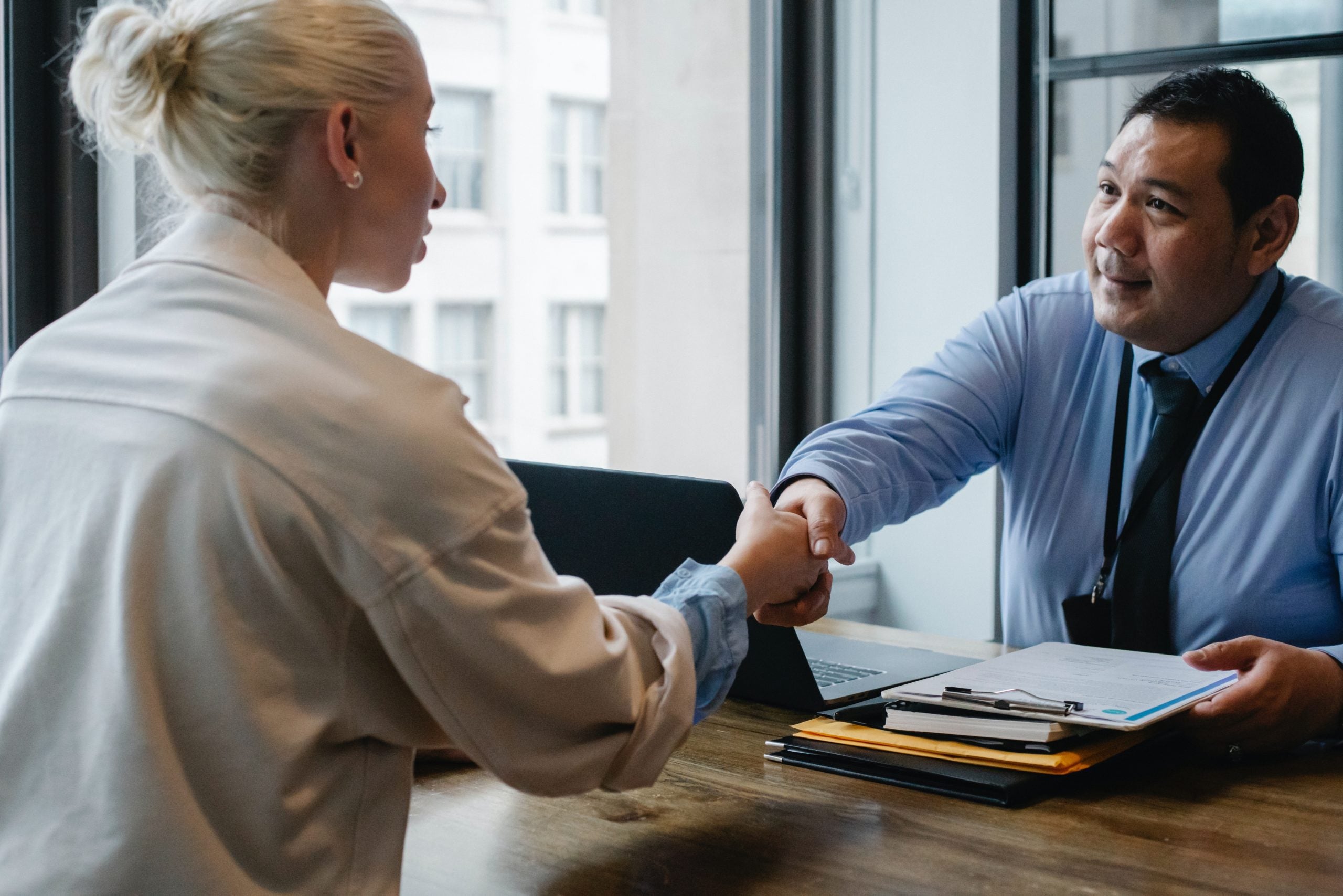 A picture of two professionals shaking hands as this article is about the Top Venture Capital or VC firms in the cybersecurity landscape. Which investors are funding the next-generation of cybersecurity innovation? Read on to learn more.